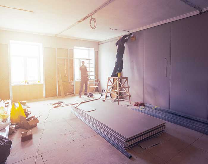 Workmen putting drywall up